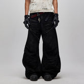 FLYERRER Distressed Waxed Zipper-Paneled Scimitar Pants
