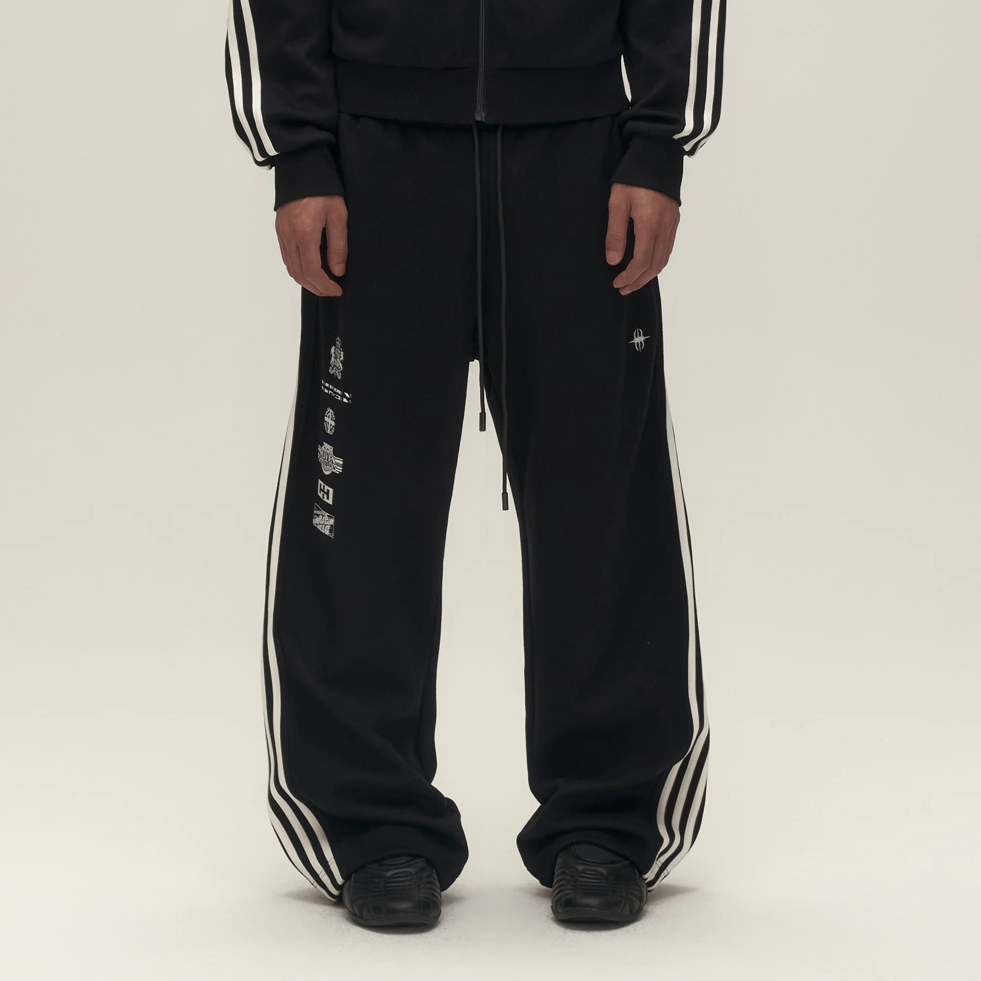 SAVAGEGROWTHWORLD Back-Arc Striped Graphic Track Pants