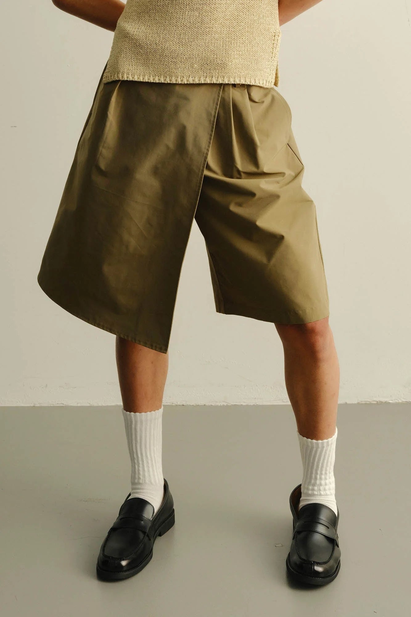 KADAKADA Asymmetrical Overlay Pleated Shorts